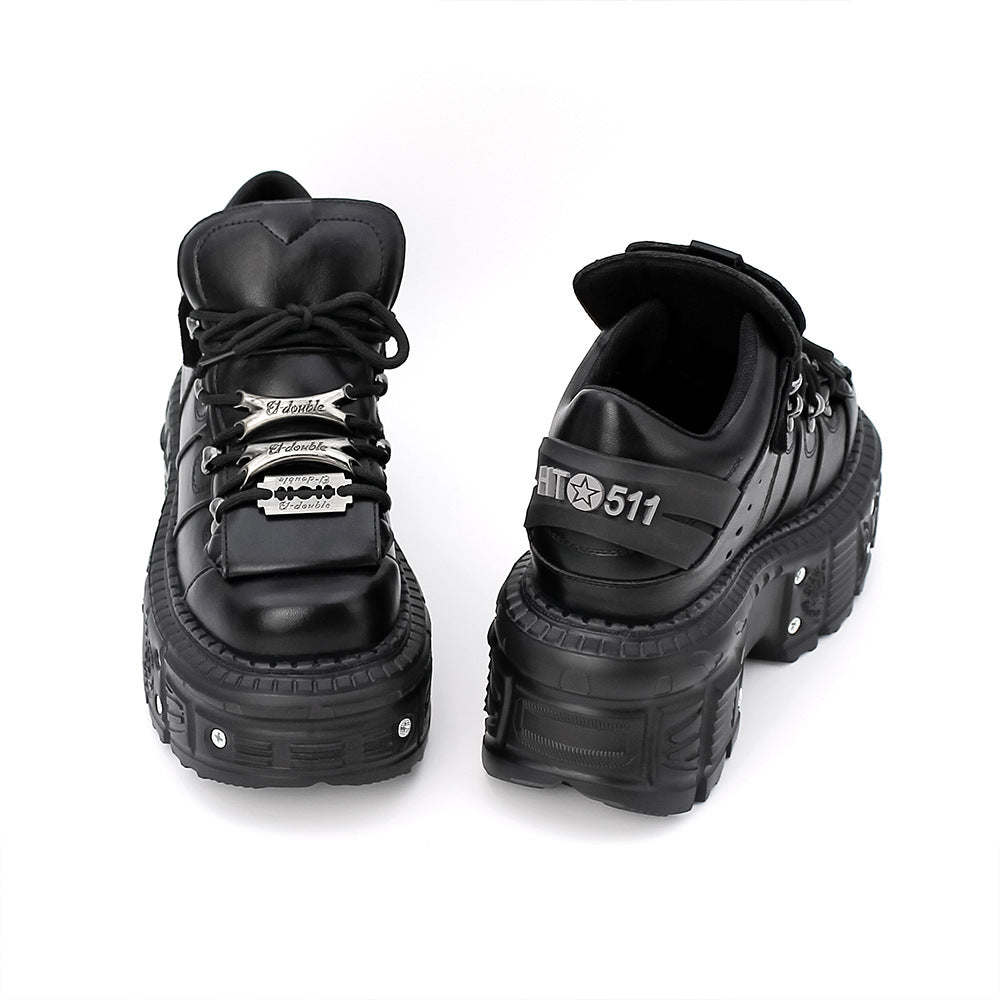 Pair of black high-top shoes with unique design elements on a white background