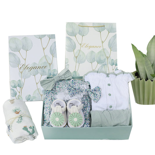 Baby gift set with clothes, shoes, and a blanket in a box, featuring 'Elegance' branding.
