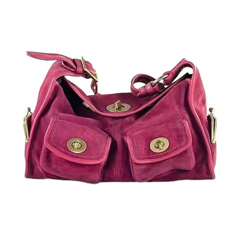 Pink handbag with gold accents on a white background