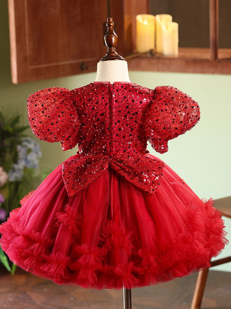 Red sequin dress on a mannequin with a blurred background