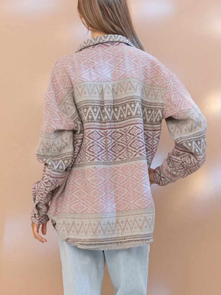 Person wearing a patterned shirt with a plain background