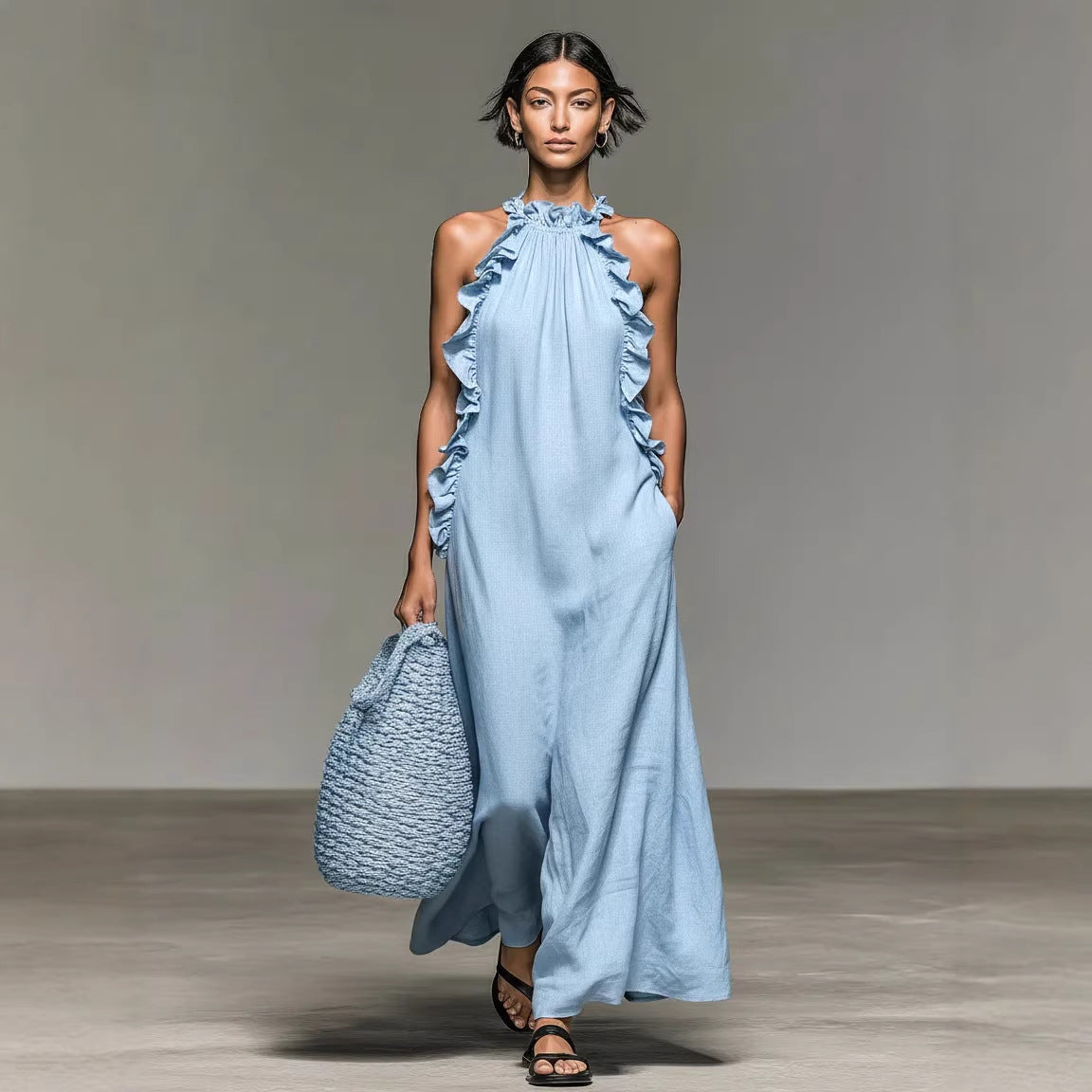 Woman wearing a light blue dress with ruffled details, holding a matching bag on a plain background. by millivan