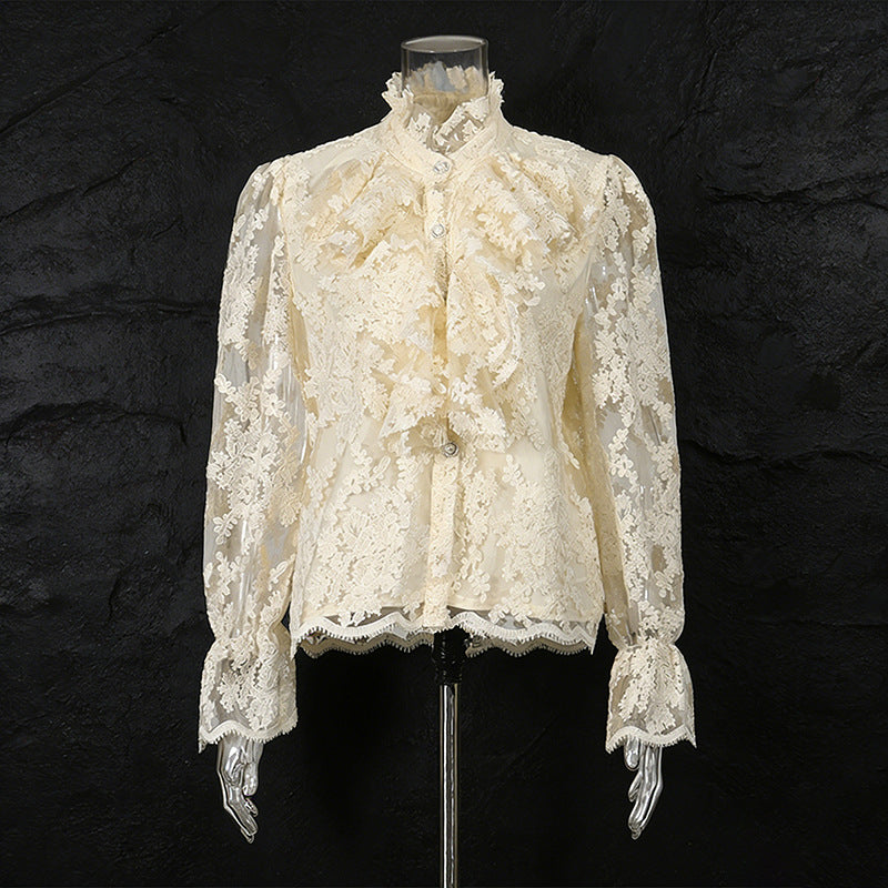 White lace blouse on a mannequin against a black background
