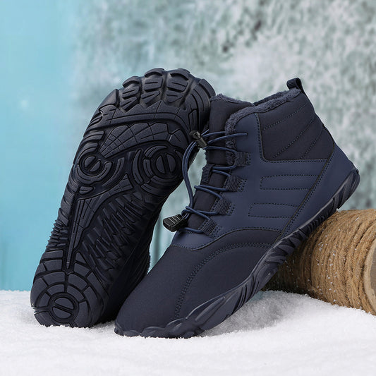 Navy blue winter boots with black soles on a snowy ground.
