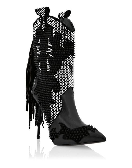 Black studded high-heeled boots with fringe on a white background