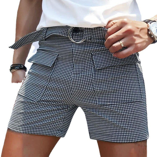 Person wearing houndstooth pattern shorts with a white background