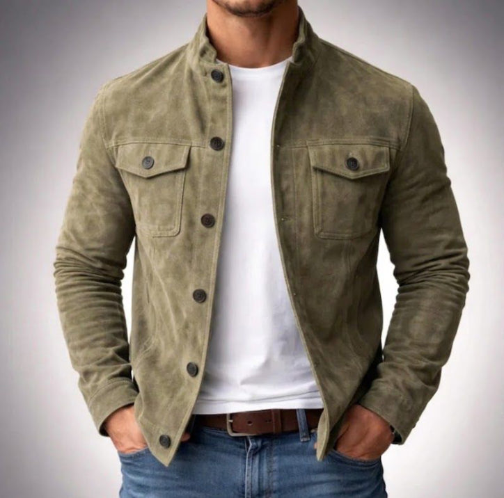 Man wearing a green suede jacket over a white shirt with a gray background