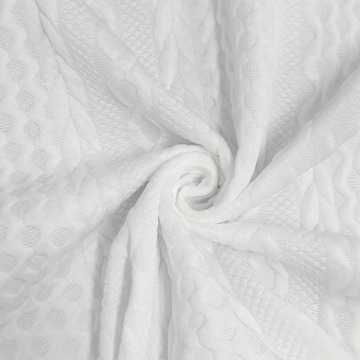 Close-up of textured white fabric with a swirl pattern