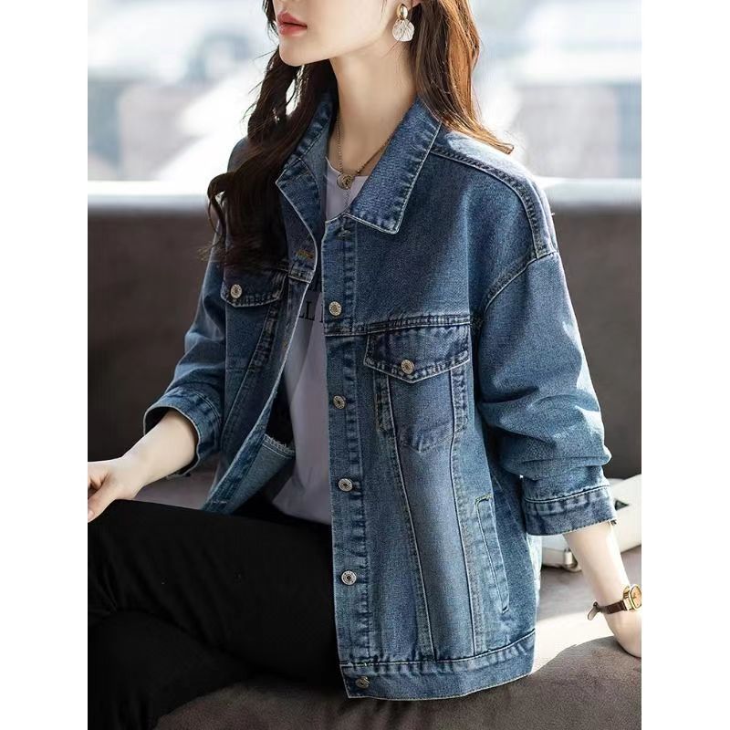 Person wearing a denim jacket with a blurred background