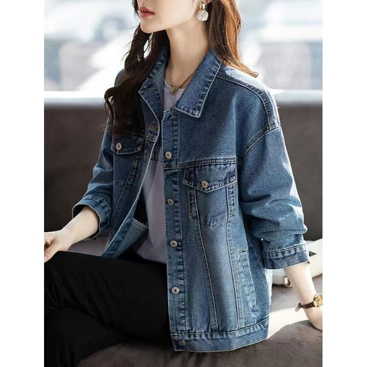 Person wearing a denim jacket with a blurred background