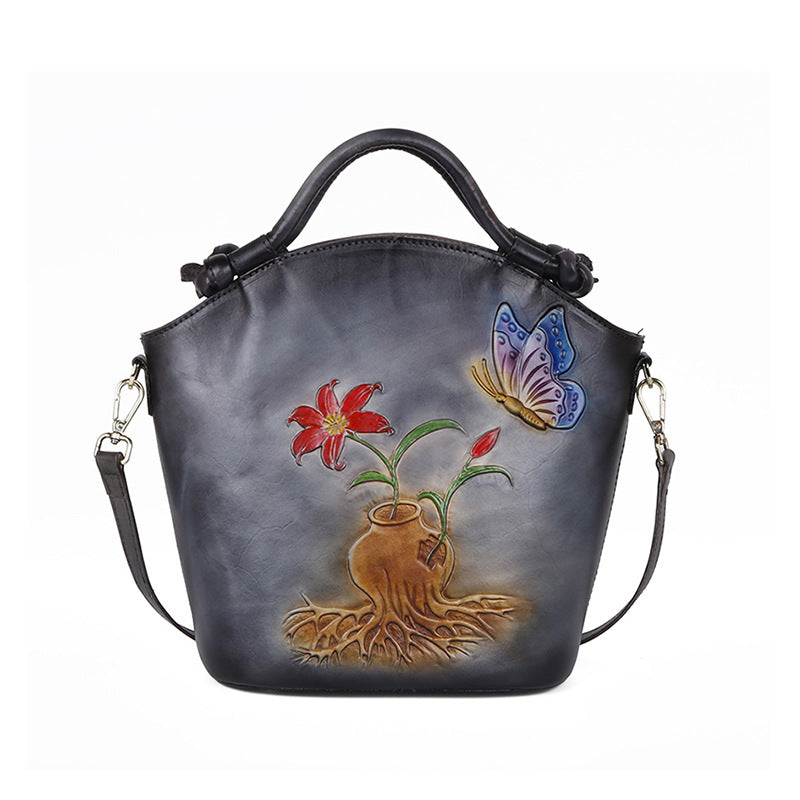 Handbag with floral and butterfly design on a white background