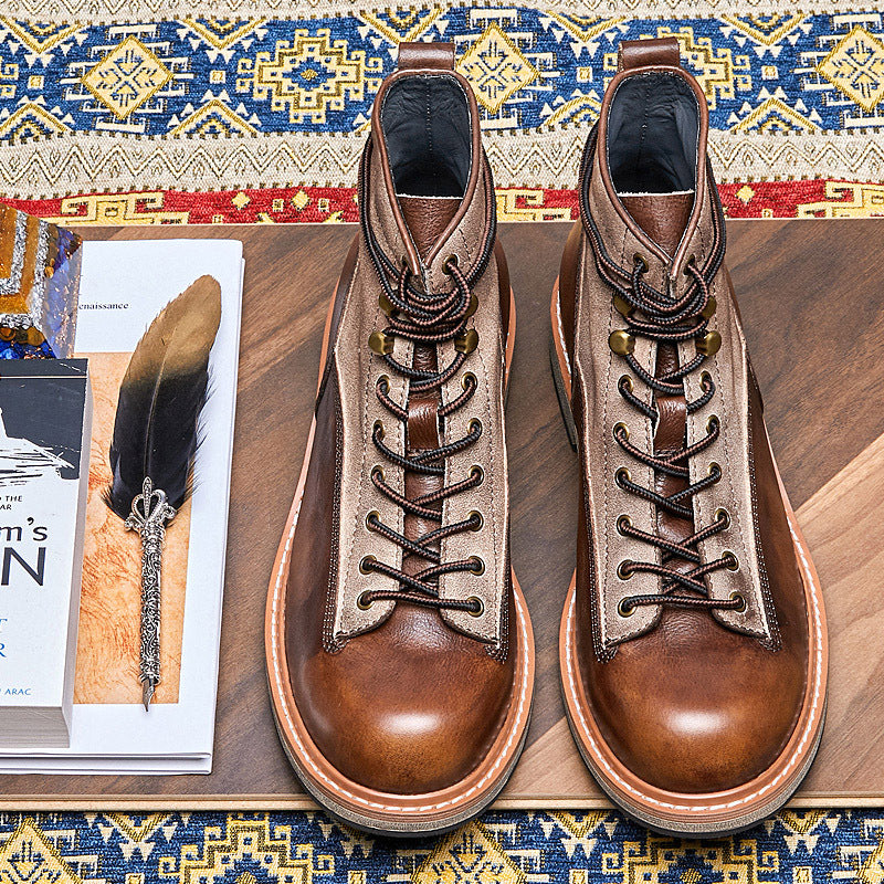 Pair of brown leather boots on a wooden surface with a patterned rug in the background