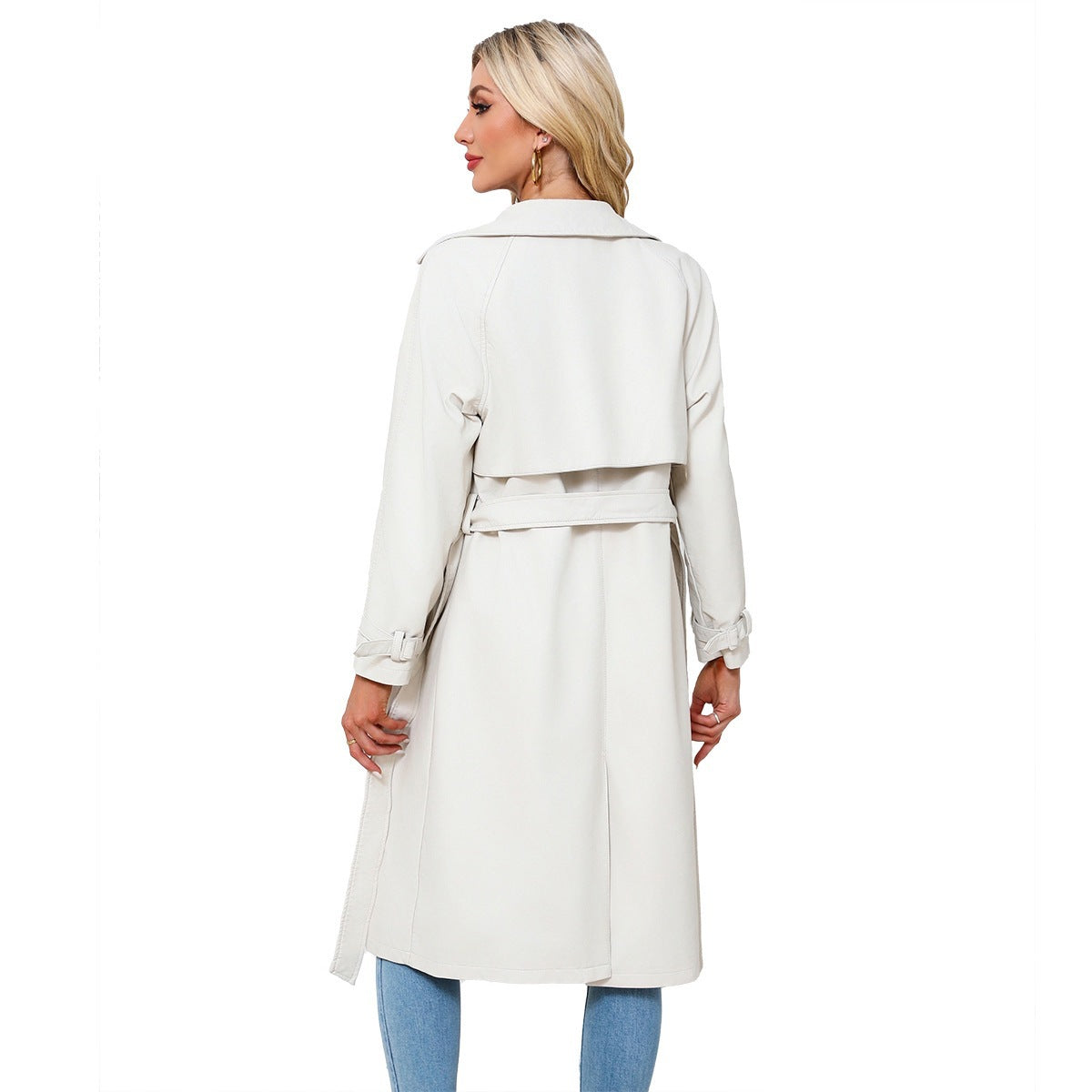 Woman wearing a white trench coat on a white background