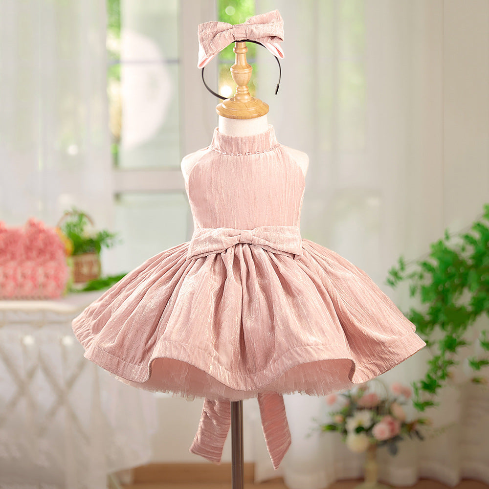Pink dress on a mannequin with a blurred indoor background