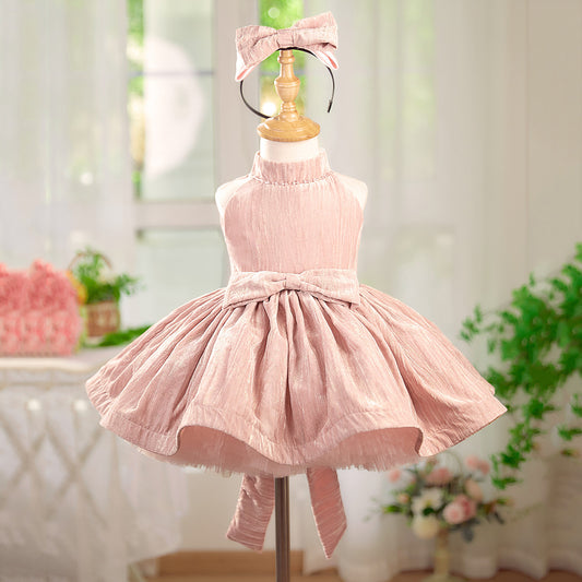 Pink dress on a mannequin with a blurred indoor background