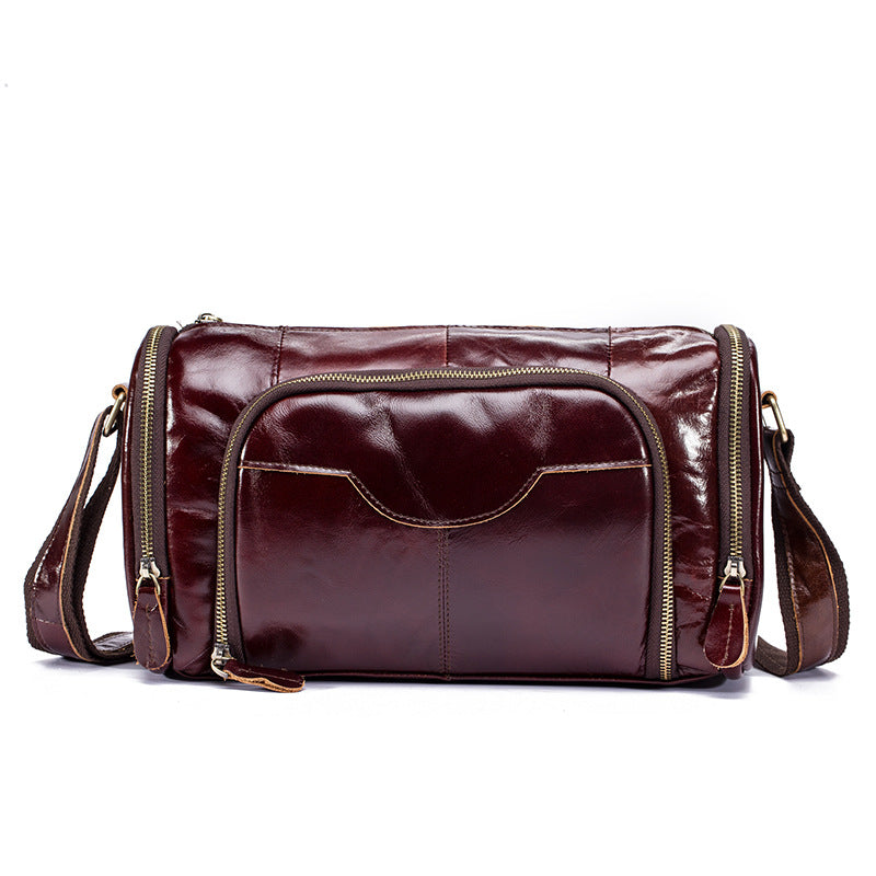 Brown leather bag with gold zippers on a white background