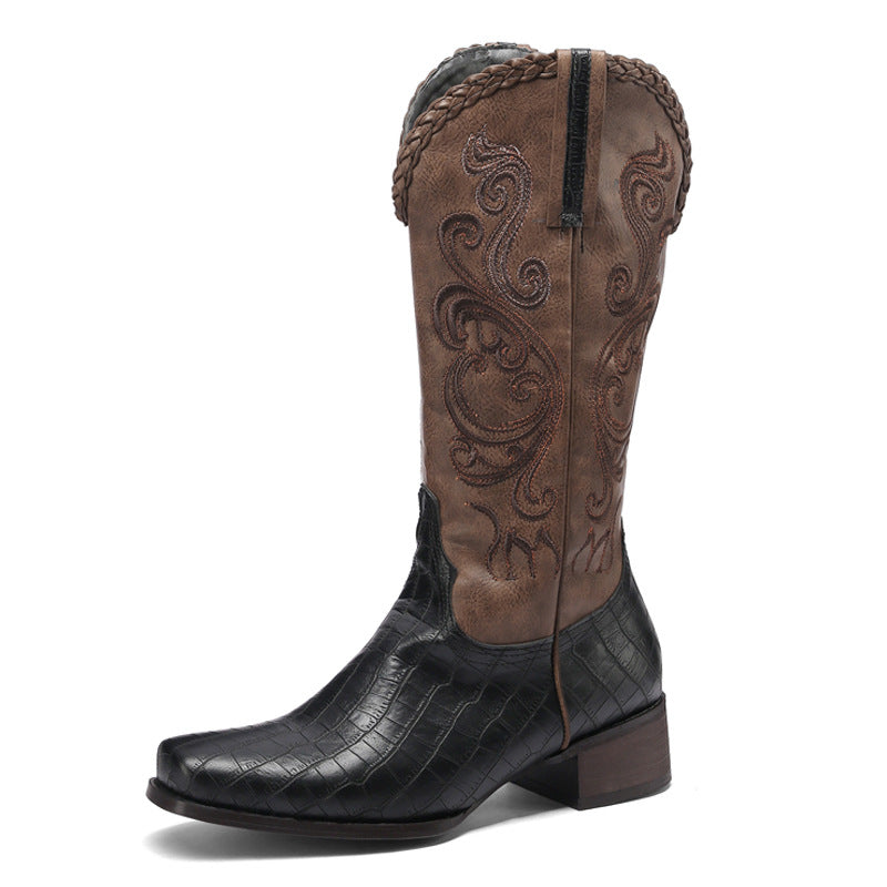 Brown and black cowboy boot with intricate design on a white background