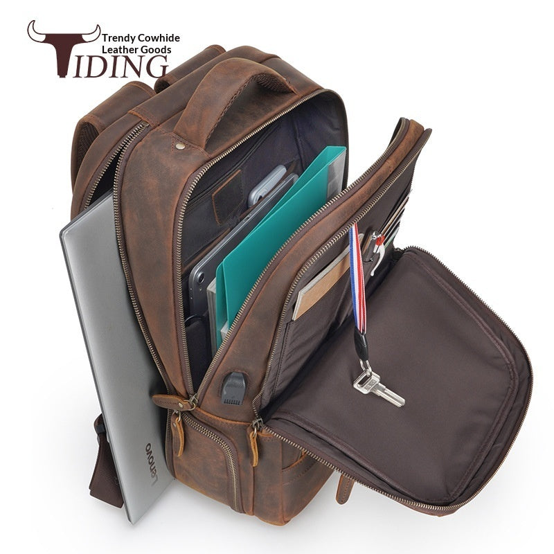 Brown leather backpack with compartments and a visible brand logo on a white background
