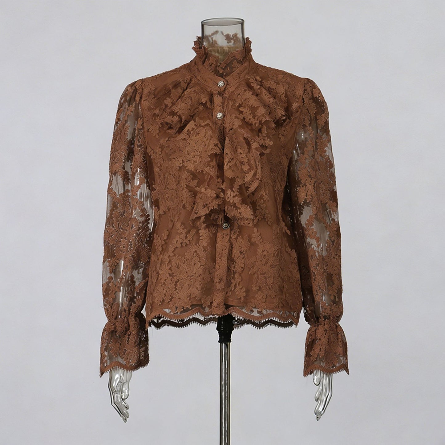 Brown lace blouse on a mannequin against a gray background