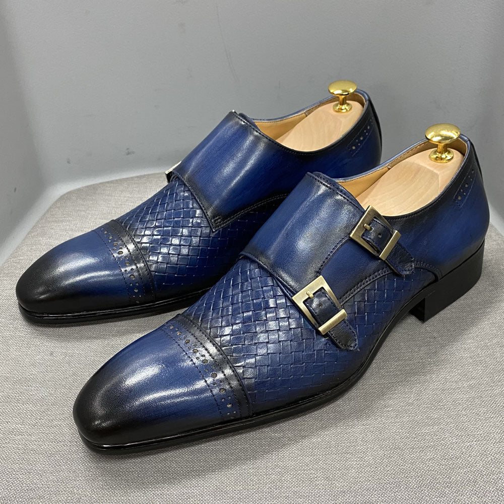 Blue leather shoes with gold buckles on a gray surface