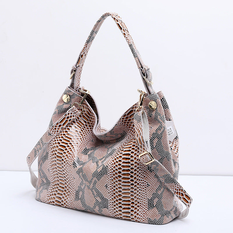 Snakeskin pattern handbag on a white background