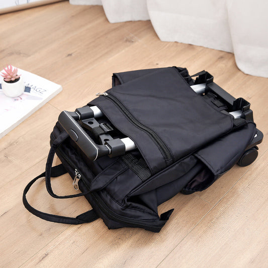 Black suitcase with wheels on a wooden floor