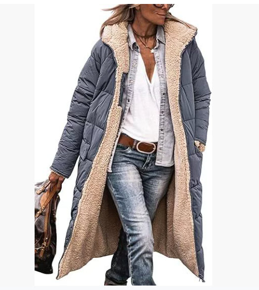 Person wearing a long gray coat with beige sherpa lining on a white background