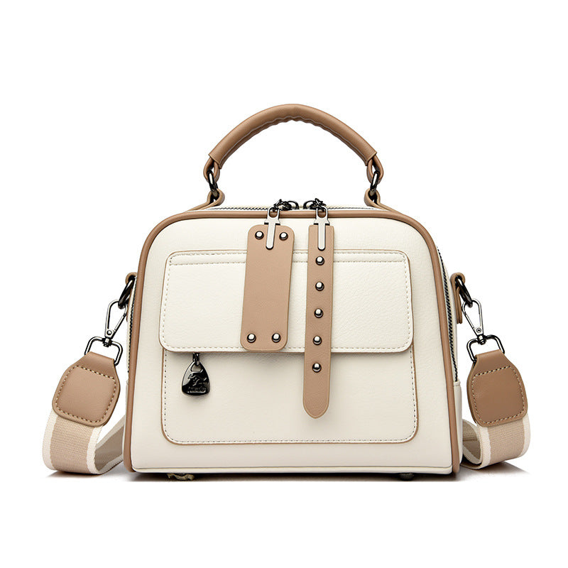 White handbag with brown accents on a white background