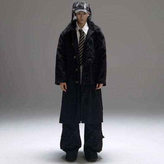 Person wearing a long black coat with fur lining, a hat, and a tie on a gray background