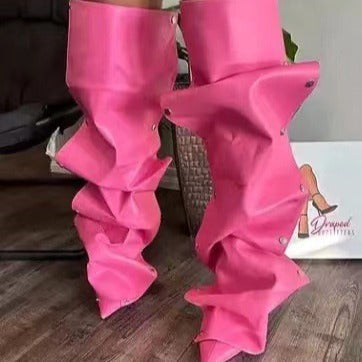 Pink leg warmers on a person's legs with a blurred background
