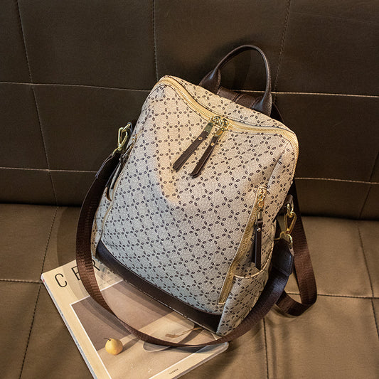 Patterned backpack with brown straps on a tiled floor