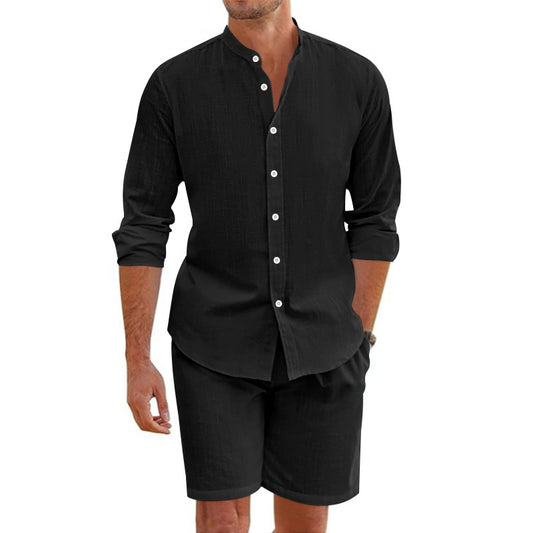 Man wearing a black long-sleeve shirt and shorts set on a white background