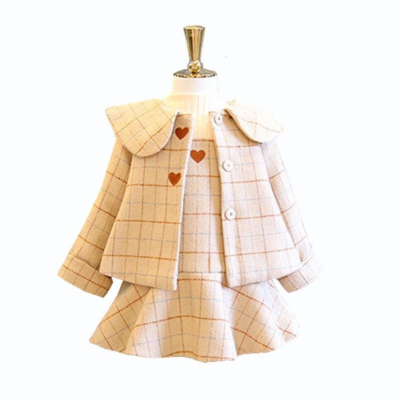 Plaid dress with heart patterns on a mannequin against a white background