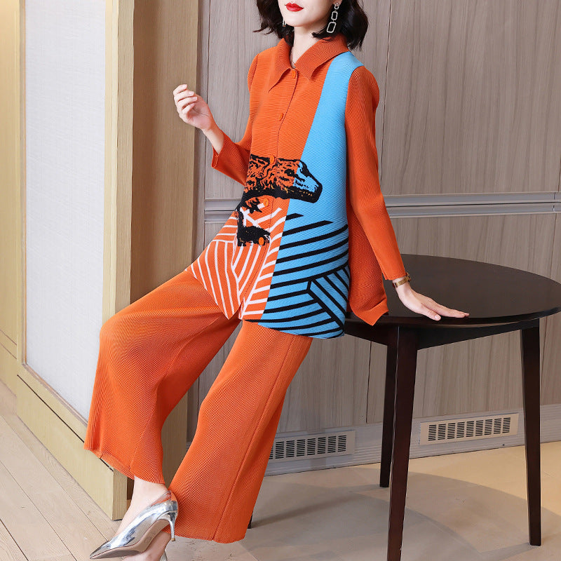 Woman in an orange and blue outfit sitting on a chair indoors.