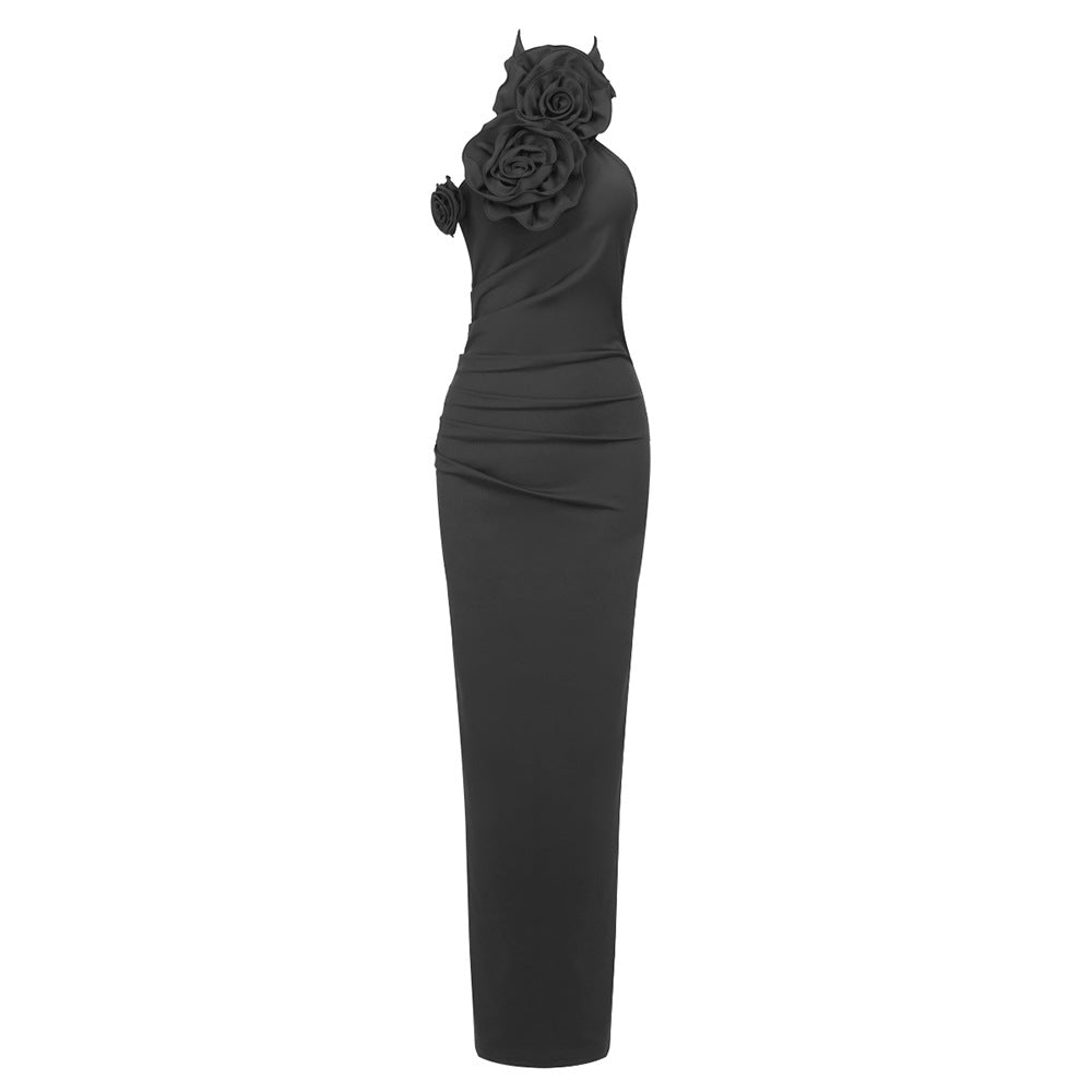 Black evening gown with floral headpiece on a white background