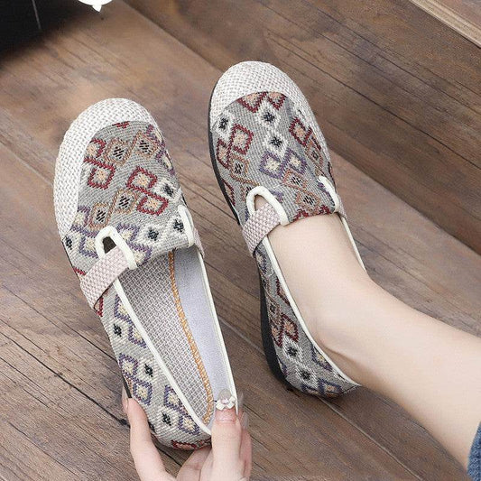 Pair of patterned shoes on a wooden floor