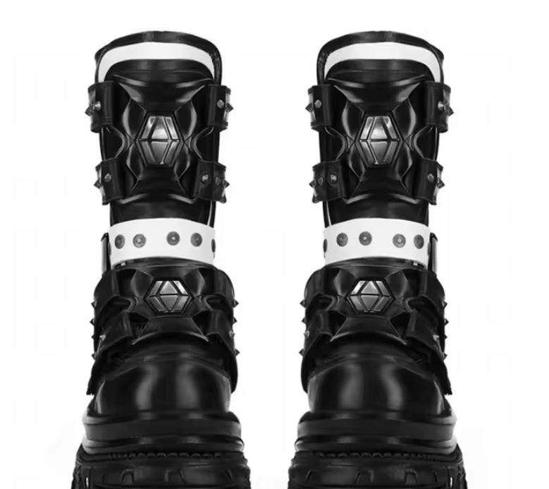 Pair of black and white boots with geometric designs on a white background