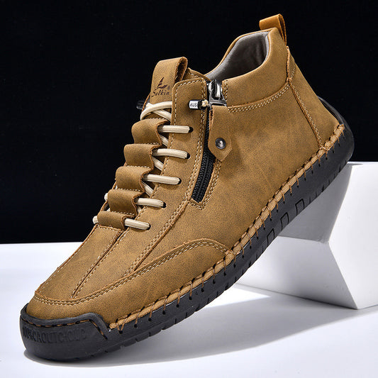 Brown leather boot with a zipper on a white platform against a black background