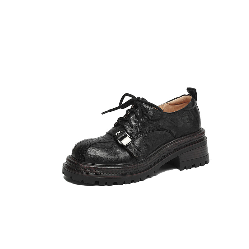 Black leather shoe with a buckle on a white background