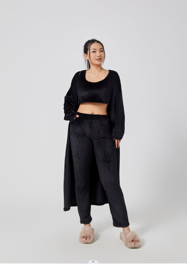 Woman wearing a black outfit on a white background