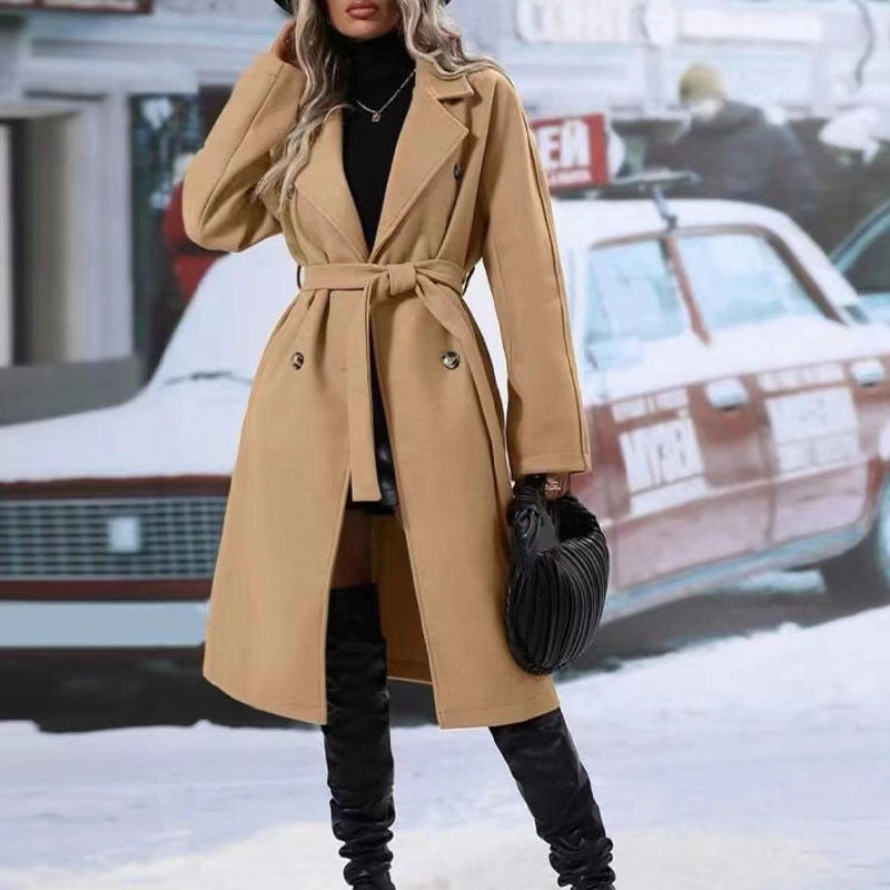Woman wearing a beige trench coat with a blurred background