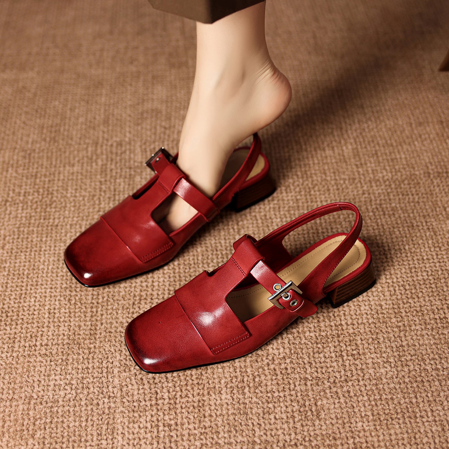 Red sandals on a textured brown surface