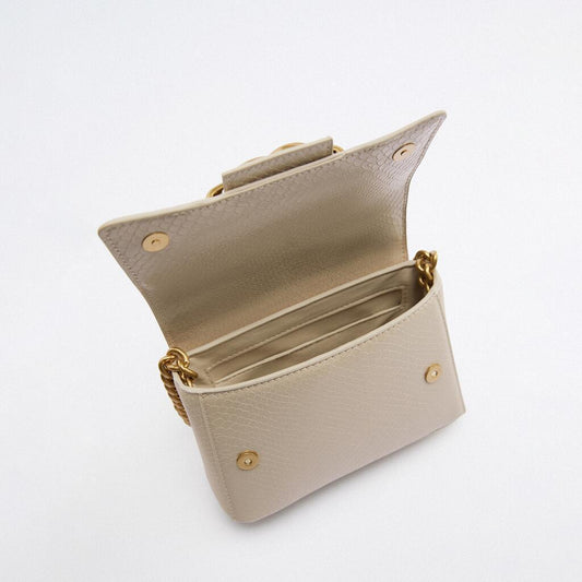 Beige handbag with gold accents on a white background