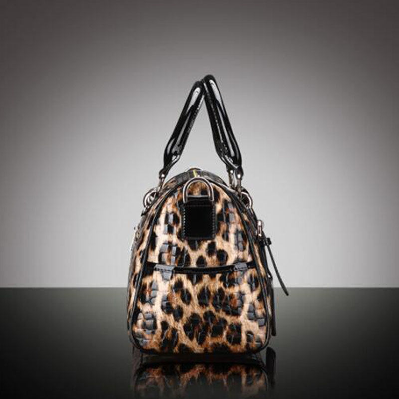 Leopard print handbag with black accents on a gradient gray background