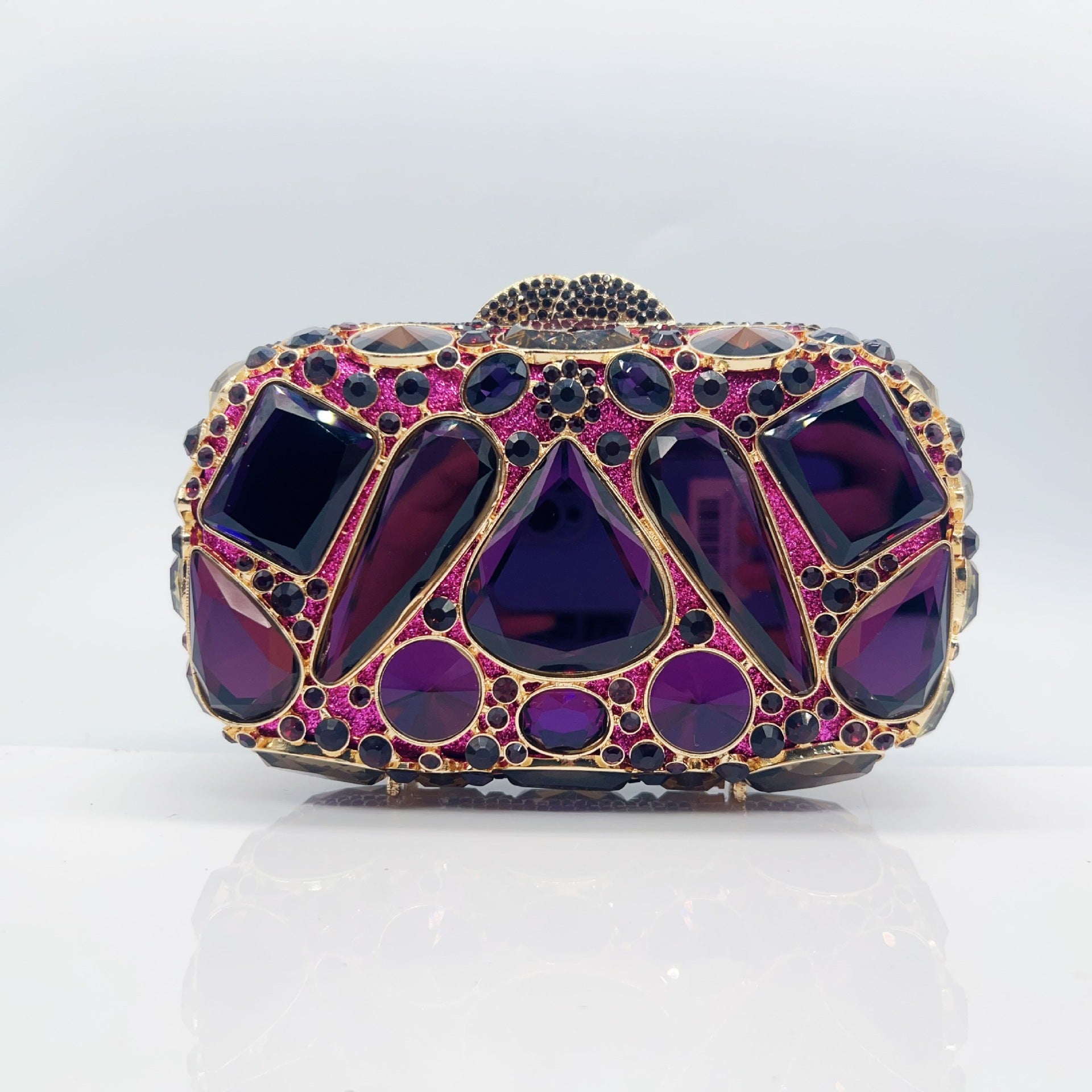 Elegant clutch with purple gemstones on a light gray background
