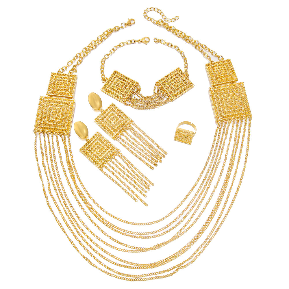 Gold jewelry set including necklace, earrings, and bracelet on a white background