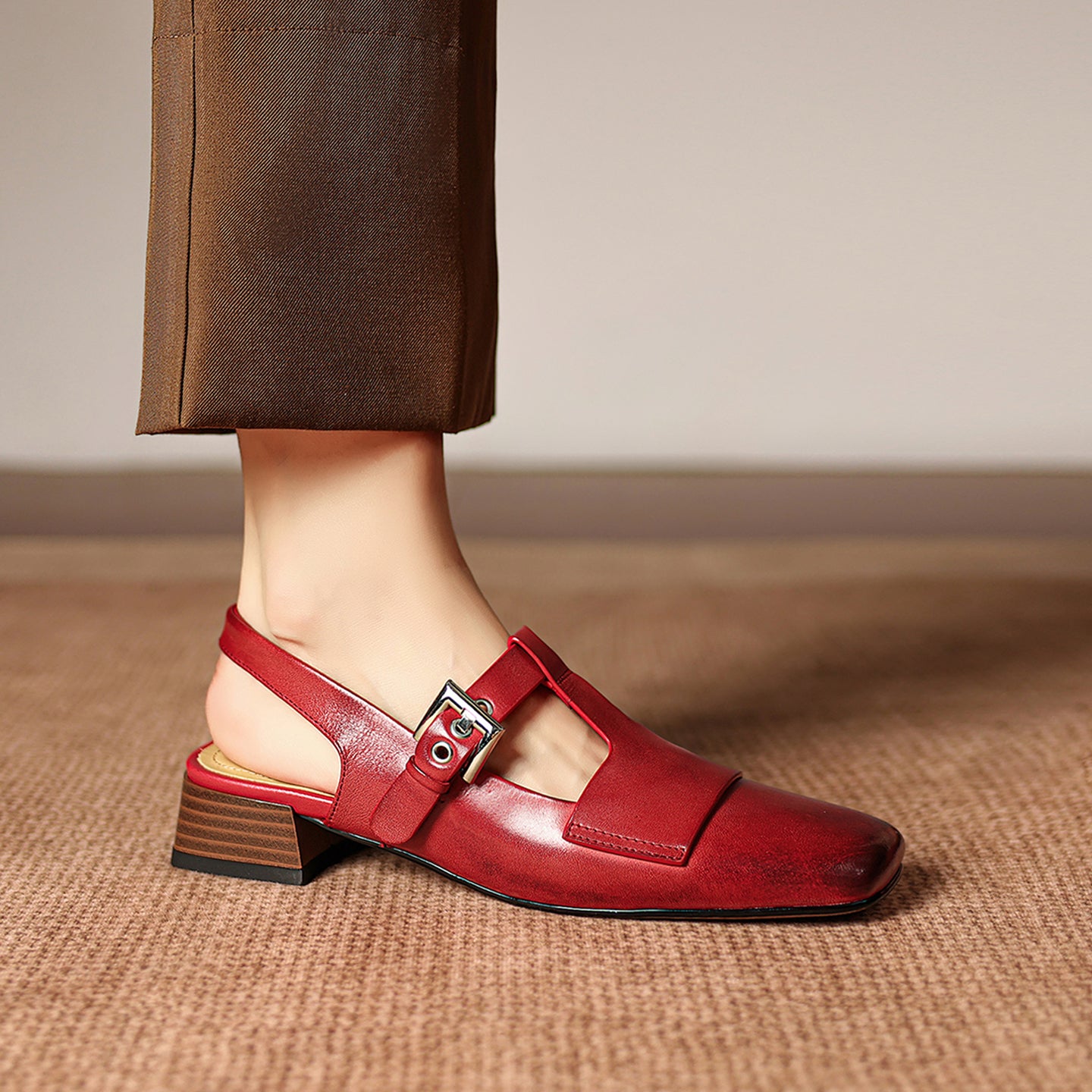 Red sandal with a strap on a neutral background