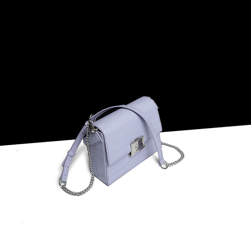 Purple handbag with chain detail on a white background