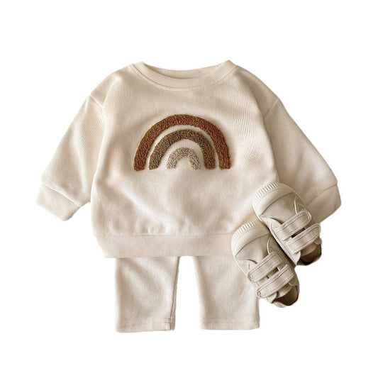 Children's outfit with rainbow design on a white background