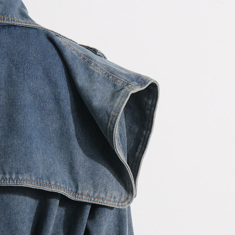 Close-up of a blue denim jacket on a light gray background